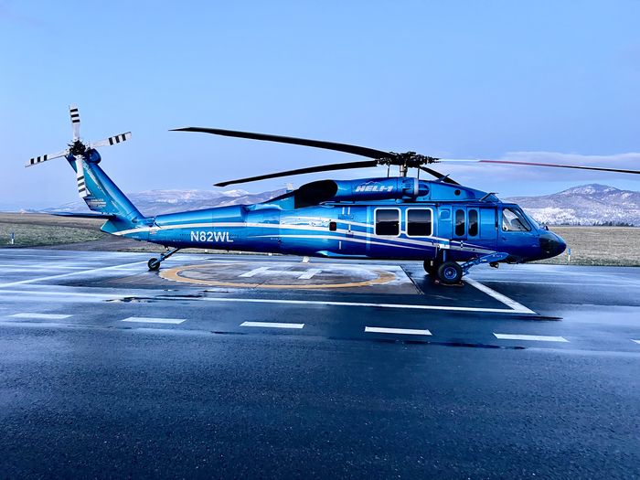 Blue UH-60 N829WL in wet conditions on ramp