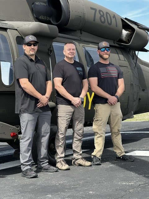 Team photo in front of UH-60 Black Hawk 7801
