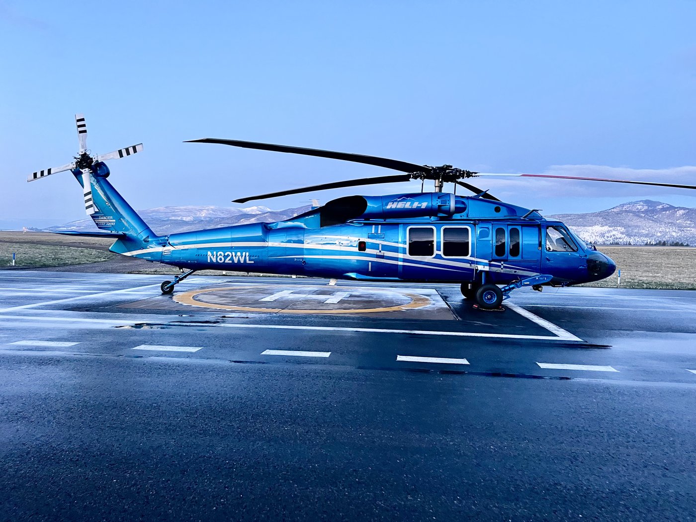Blue UH-60 N829WL in wet conditions on ramp